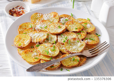 Roasted Potato Slices with Parmesan Cheese Top View Roasted Potato Slices with Parmesan Cheese Top View 135376306