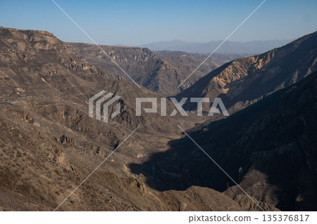 Panoramic view of a deep mountain gorge and rugged ridgelines seen from the Arsnadzor watchtower, with layered hills and dry winter landscape Panoramic view of a deep mountain gorge and rugged ridgelines seen from the Arsnadzor watchtower, with layered hills and dry winter landscape 135376817
