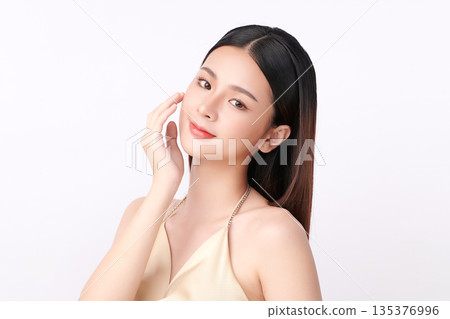 A beautiful young Asian woman with clean, fresh skin against a white background. Skincare, facial treatment, cosmetology, beauty, and spa. An elegant portrait of an Asian woman. A beautiful young Asian woman with clean, fresh skin against a white background. Skincare, facial treatment, cosmetology, beauty, and spa. An elegant portrait of an Asian woman. 135376996