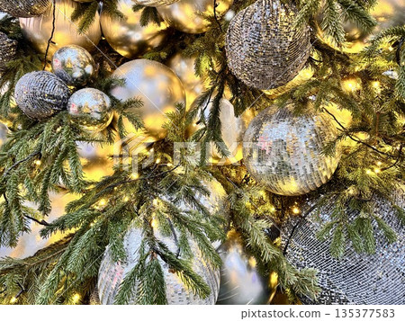 a natural Christmas tree decorated with Christmas toys, balls 135377583