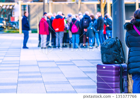 Tokyo cityscape in Japan. Suitcases... The Marunouchi Station Square in front of Tokyo Station is bustling with foreign tourists. In the background is a group of foreign tourists. Tokyo cityscape in Japan. Suitcases... The Marunouchi Station Square in front of Tokyo Station is bustling with foreign tourists. In the background is a group of foreign tourists. 135377766