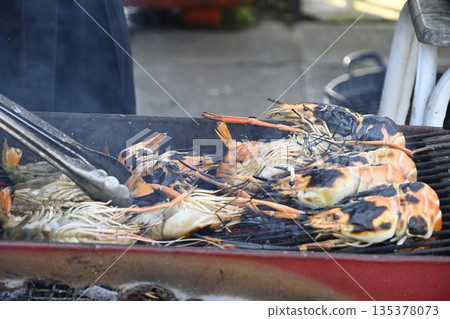 Grilled prawn seafood street food outdoor cooking charcoal grill smoky flavor tongs smoky grilled prawn seafood charcoal grill 135378073