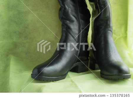 Pair of women's fashion black leather boots Pair of women's fashion black leather boots 135378165