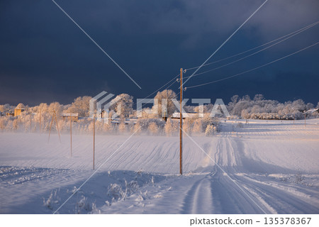 Golden Sunlight Touching a Village Under Dark Clouds Golden Sunlight Touching a Village Under Dark Clouds 135378367