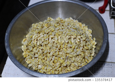 Stainless steel bowl split lentil yellow legume raw pulse healthy food closeup view rustic kitchen cooking ingredient organic Stainless steel bowl split lentil yellow legume raw pulse healthy food closeup view rustic kitchen cooking ingredient organic 135378417
