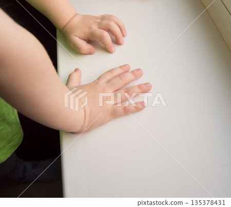 Child hand showing the five fingers isolated on a white background Child hand showing the five fingers isolated on a white background 135378431