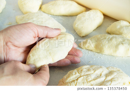 Female hands making biscuits and pie dough, close-up Female hands making biscuits and pie dough, close-up 135378450