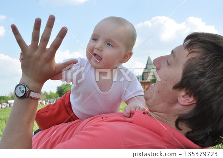Joyful Baby Laughing and Reaching for High Five Joyful Baby Laughing and Reaching for High Five 135379723
