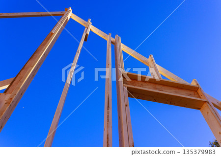 Workers are constructing wooden frame for building beams timber framework construction 135379983