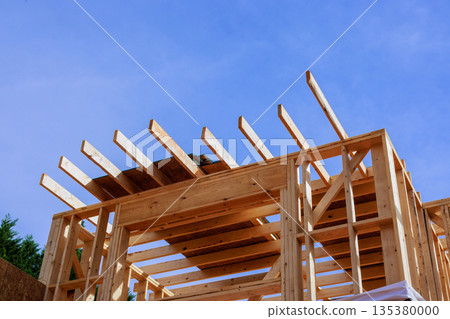 Workers build wooden frame structure with beams under assembly together new house 135380000