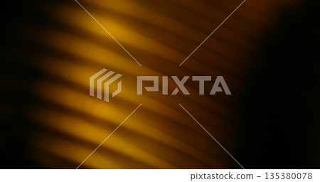 Line light blur. Flash leak texture. Yellow brown corrugated optical effect on dark black background. Color abstract illumination free space. Line light blur. Flash leak texture. Yellow brown corrugated optical effect on dark black background. Color abstract illumination free space. 135380078