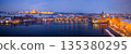 High resolution winter panorama of Prague featuring Charles Bridge, Prague Castle and the Vltava River at dusk. Snow covered historic city illuminated by warm lights creates a magical European winter 135380295