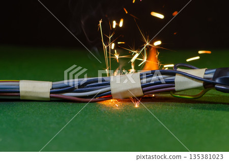Sparks and smoke appear in electrical wiring during a critical malfunction. Sparks and smoke appear in electrical wiring during a critical malfunction. 135381023