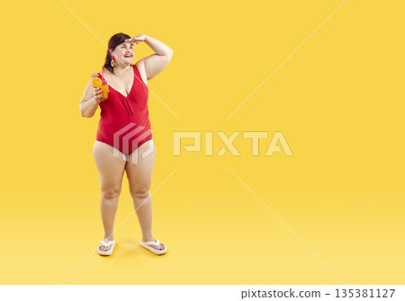 Fat woman in red swimsuit holding cocktail looking far away with hand on yellow background. Fat woman in red swimsuit holding cocktail looking far away with hand on yellow background. 135381127