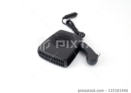 Compact black car heater powered by cigarette lighter, isolated on white background, portable automotive defrost device. Compact black car heater powered by cigarette lighter, isolated on white background, portable automotive defrost device. 135381498