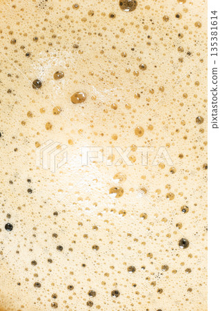 Macro texture of golden coffee foam with many small bubbles. Macro texture of golden coffee foam with many small bubbles. 135381614