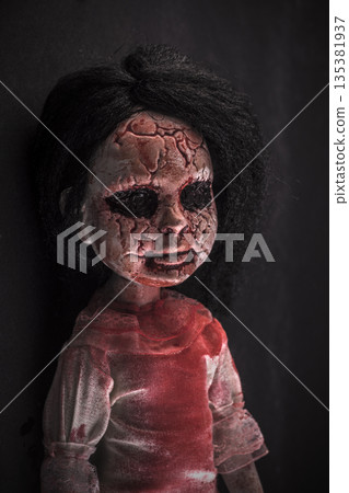 Creepy bloody doll face with long black hair in the dark Creepy bloody doll face with long black hair in the dark 135381937