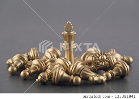 Victorious golden king with group of lying chess pieces Victorious golden king with group of lying chess pieces 135381941