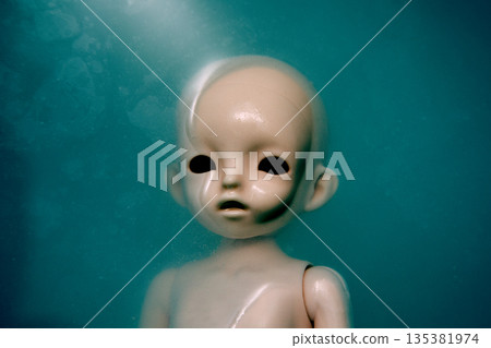 Creepy doll face in dark dirty blue water Creepy doll face in dark dirty blue water 135381974