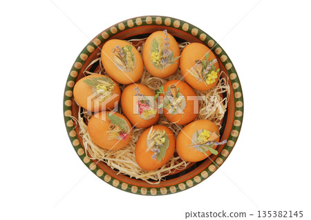 Easter eggs decorated with dried flowers in ceramic plate. Isolate on a white background. Easter traditions. Variety of homemade foods. Country style. Easter eggs decorated with dried flowers in ceramic plate. Isolate on a white background. Easter traditions. Variety of homemade foods. Country style. 135382145