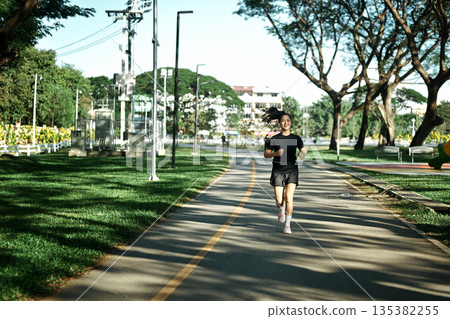 Sportswoman morning jogging at park urban city 135382255