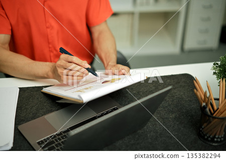 Document with a man checking searching document legal prepare paperwork or report for analysis 135382294