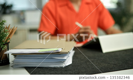 Focus with Stack of Documents paper folders on office desk Focus with Stack of Documents paper folders on office desk 135382346