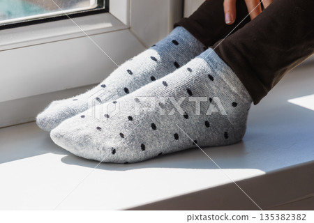 Woman wearing grey dotted socks Woman wearing grey dotted socks 135382382