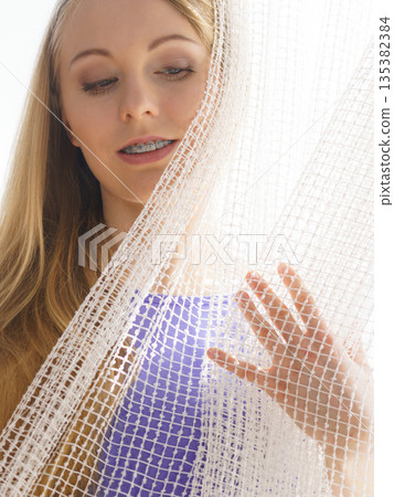 Woman relaxing on windowsill Woman relaxing on windowsill 135382384