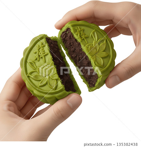 Hand breaking apart matcha mooncake with lotus seed paste, symbolizing family reunion and the harvest moon celebration 135382438