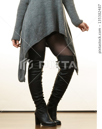 Woman wearing gray long top sweater tunic Woman wearing gray long top sweater tunic 135382487