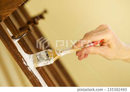 Person renovating wooden hanger Person renovating wooden hanger 135382493