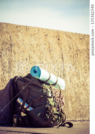 Hiking backpack camping equipment outdoor on grunge wall Hiking backpack camping equipment outdoor on grunge wall 135382540