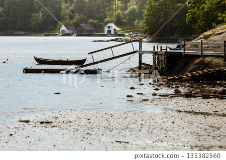 Old boat on lake shore coast Old boat on lake shore coast 135382560