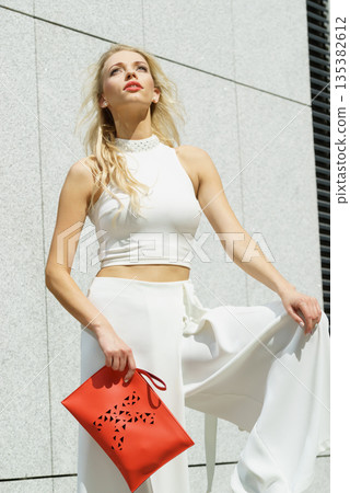 Woman wearing crop top and culottes Woman wearing crop top and culottes 135382612