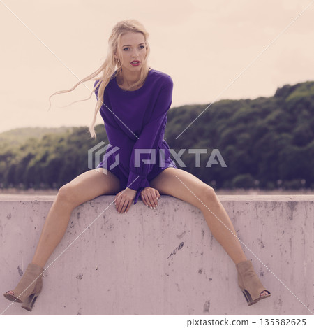 Fashion model wearing blue jumpsuit Fashion model wearing blue jumpsuit 135382625