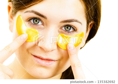 Woman with gold patches under eyes 135382692
