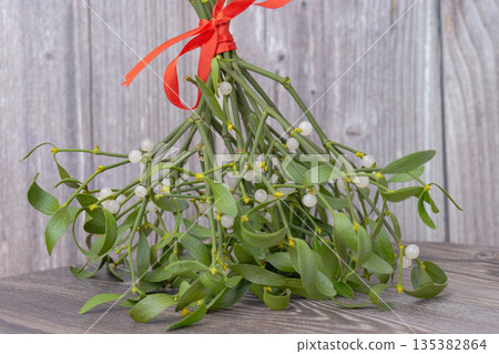 photo of a mistletoe bouquet with a red ribbon 135382864