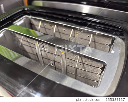 Shiny toaster with empty slots ready for breakfast toast preparation Shiny toaster with empty slots ready for breakfast toast preparation 135383137