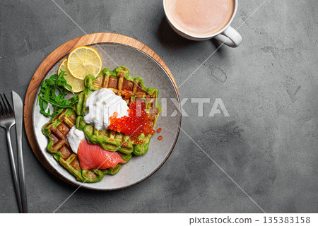 Healthy low carb breakfast with green avocado waffles, salmon, red caviar, soft cheese Healthy low carb breakfast with green avocado waffles, salmon, red caviar, soft cheese 135383158