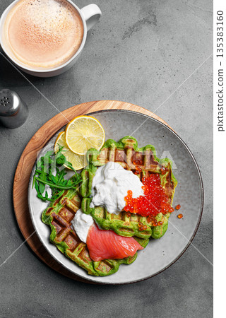 Healthy low carb breakfast with green avocado waffles, salmon, red caviar, ricotta cheese Healthy low carb breakfast with green avocado waffles, salmon, red caviar, ricotta cheese 135383160