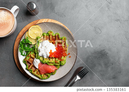 Healthy low carb breakfast with green avocado waffles, salmon, red caviar, ricotta cheese Healthy low carb breakfast with green avocado waffles, salmon, red caviar, ricotta cheese 135383161
