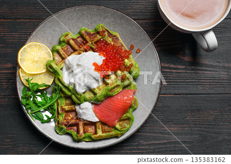 Healthy low carb breakfast with green avocado waffles, salmon, red caviar, ricotta cheese 135383162