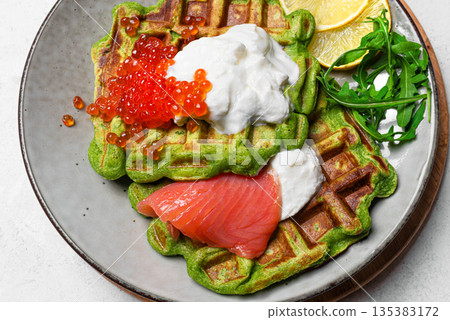 Healthy low carb breakfast with green avocado waffles, salmon, red caviar, ricotta cheese 135383172