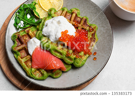 Healthy low carb breakfast with green avocado waffles, salmon, red caviar, ricotta cheese 135383173