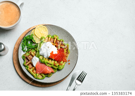Healthy low carb breakfast with green avocado waffles, salmon, red caviar, soft cheese 135383174