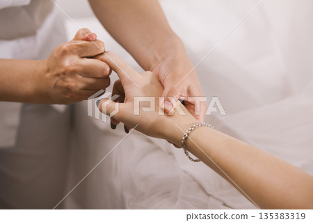 Finger massage - tibetian massage in spa salon for young woman, close up Finger massage - tibetian massage in spa salon for young woman, close up 135383319