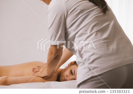 Tibetian massage in spa salon for young woman Tibetian massage in spa salon for young woman 135383321