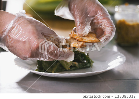 Chef serves fried chicken on the plate in restaurant Chef serves fried chicken on the plate in restaurant 135383332