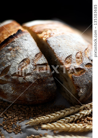 Close up of rustic sourdough bread cutting in half 135383685